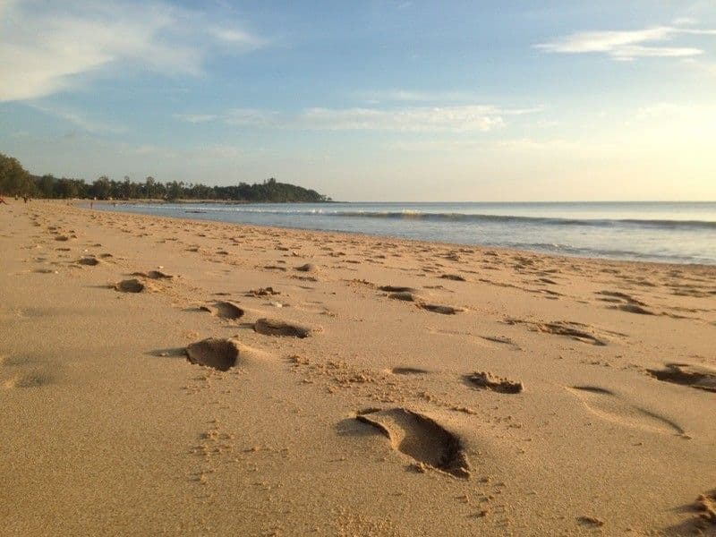 Sandy beach at Koh Lanta with footprints in the sand and calm sea