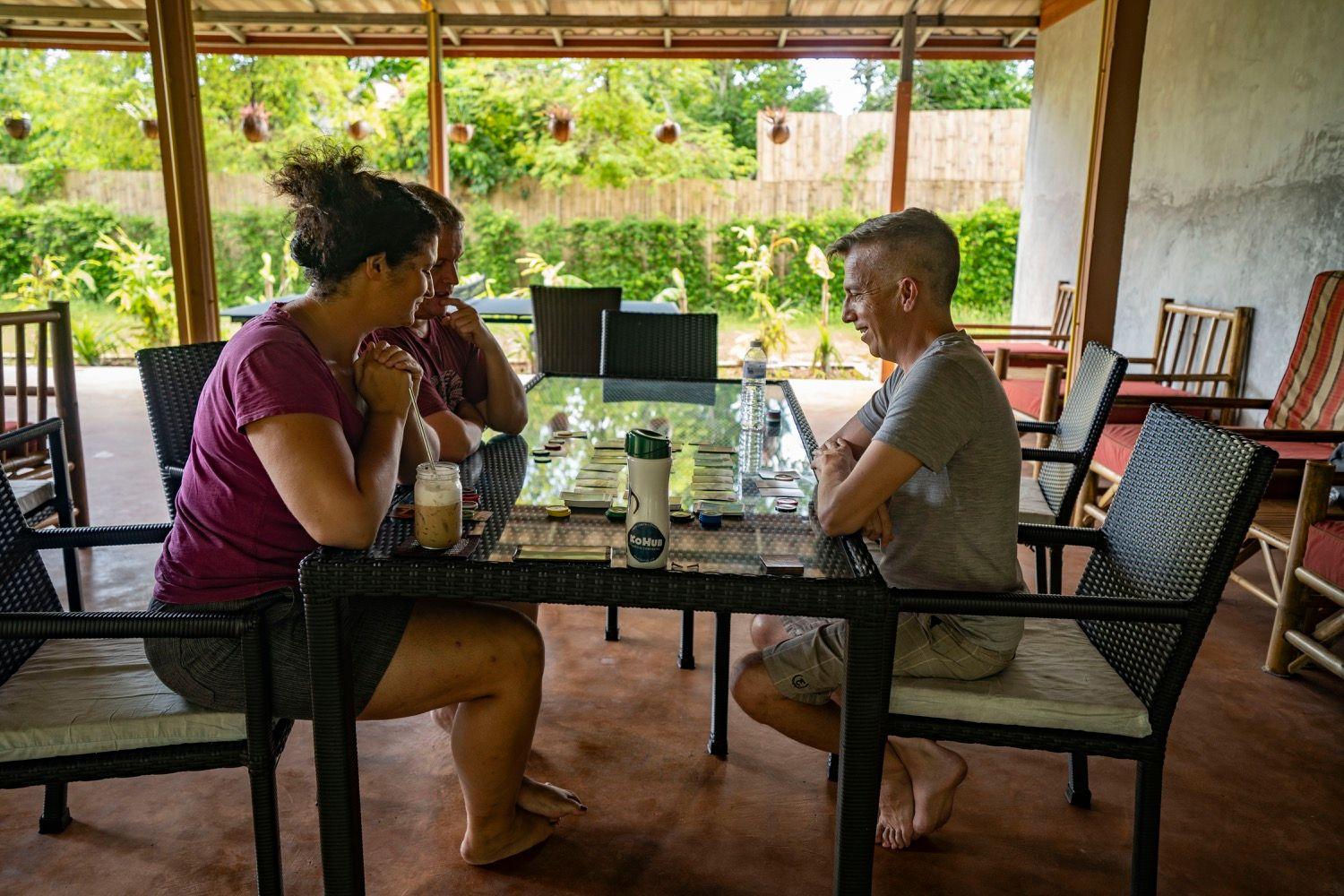 Three members sitting together at a table in the cafe area, chatting over drinks