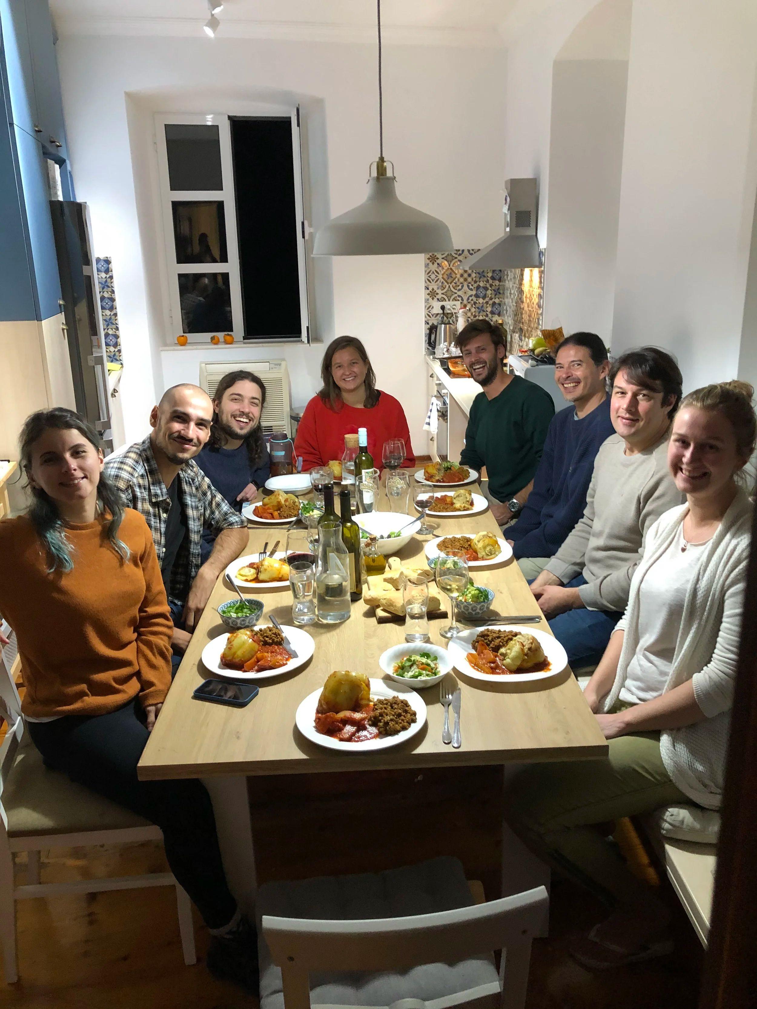 Group of coliving members sharing a meal together at the dining table