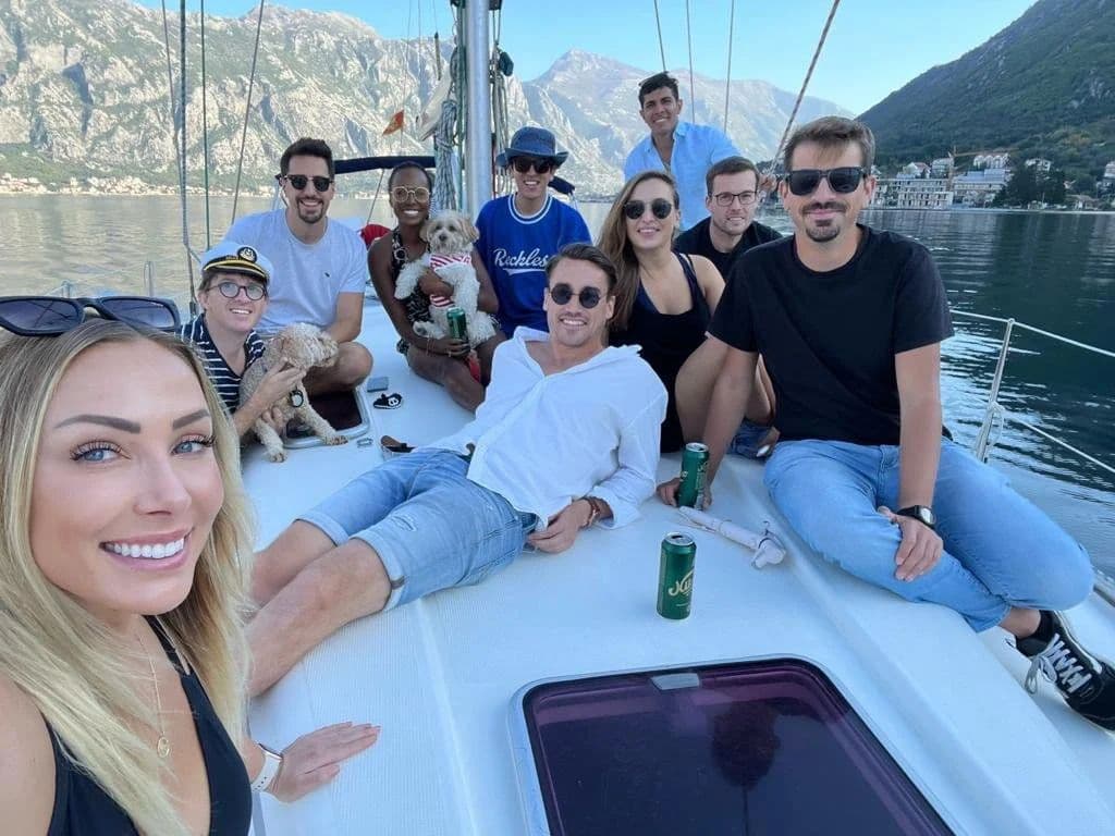 Group of coliving members on a sailing boat on Kotor Bay