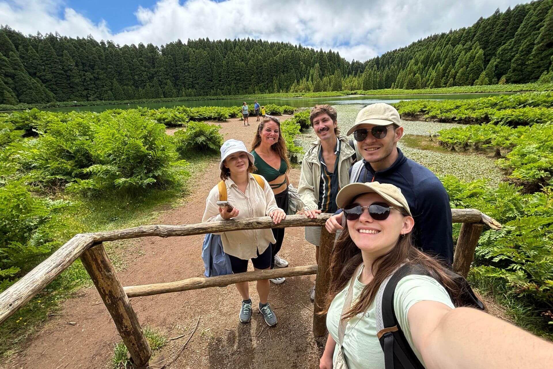 Group of Lava Coliving residents on a hike near a lake in São Miguel during winter