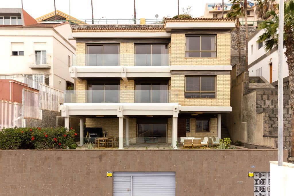 Exterior facade of the Macaw25 chalet, three-story building with balconies