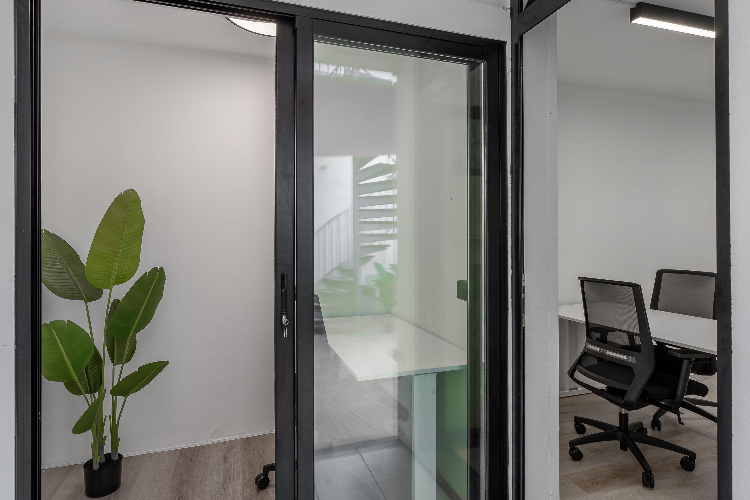 Glass-walled phone booths and private work rooms at Madeira Friends Hub