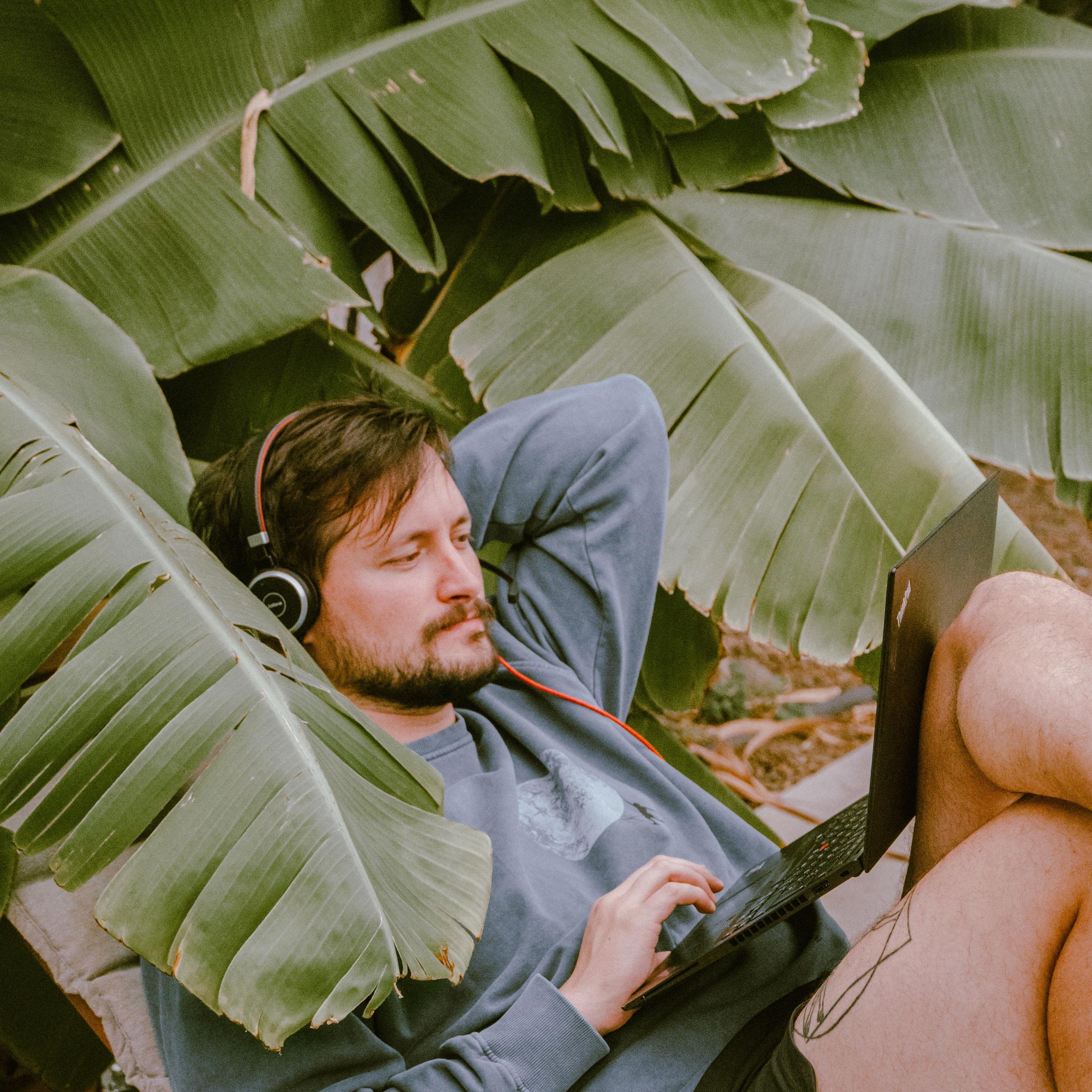 Person working in a secret spot among the banana trees at Maraya Coliving
