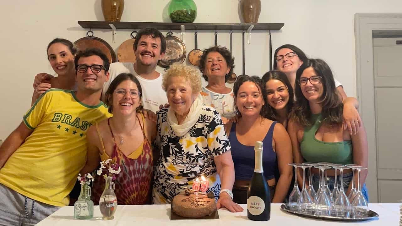 Digital nomads enjoying a communal dinner at a rural coliving in Italy at Masseria Olga