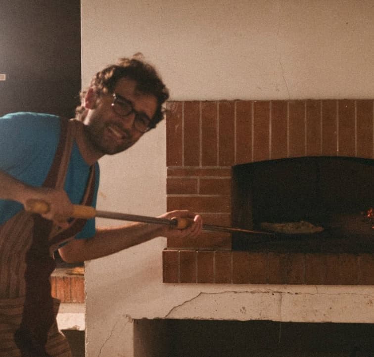 A person preparing a meal in the communal kitchen of Masseria Olga, a rural coliving space in Italy