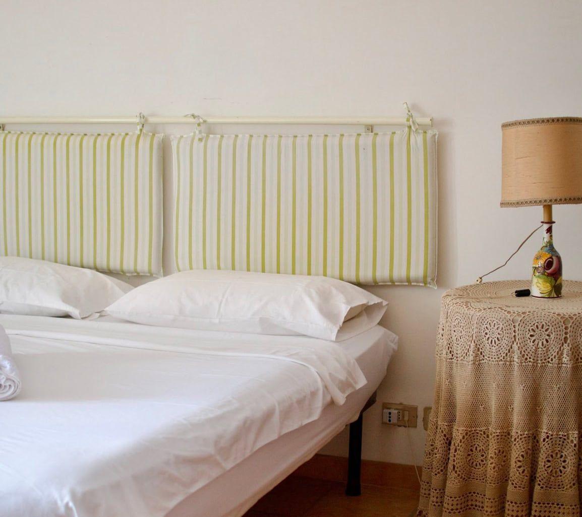 Superior double room with bed and lamp at Masseria Olga coliving in Italy