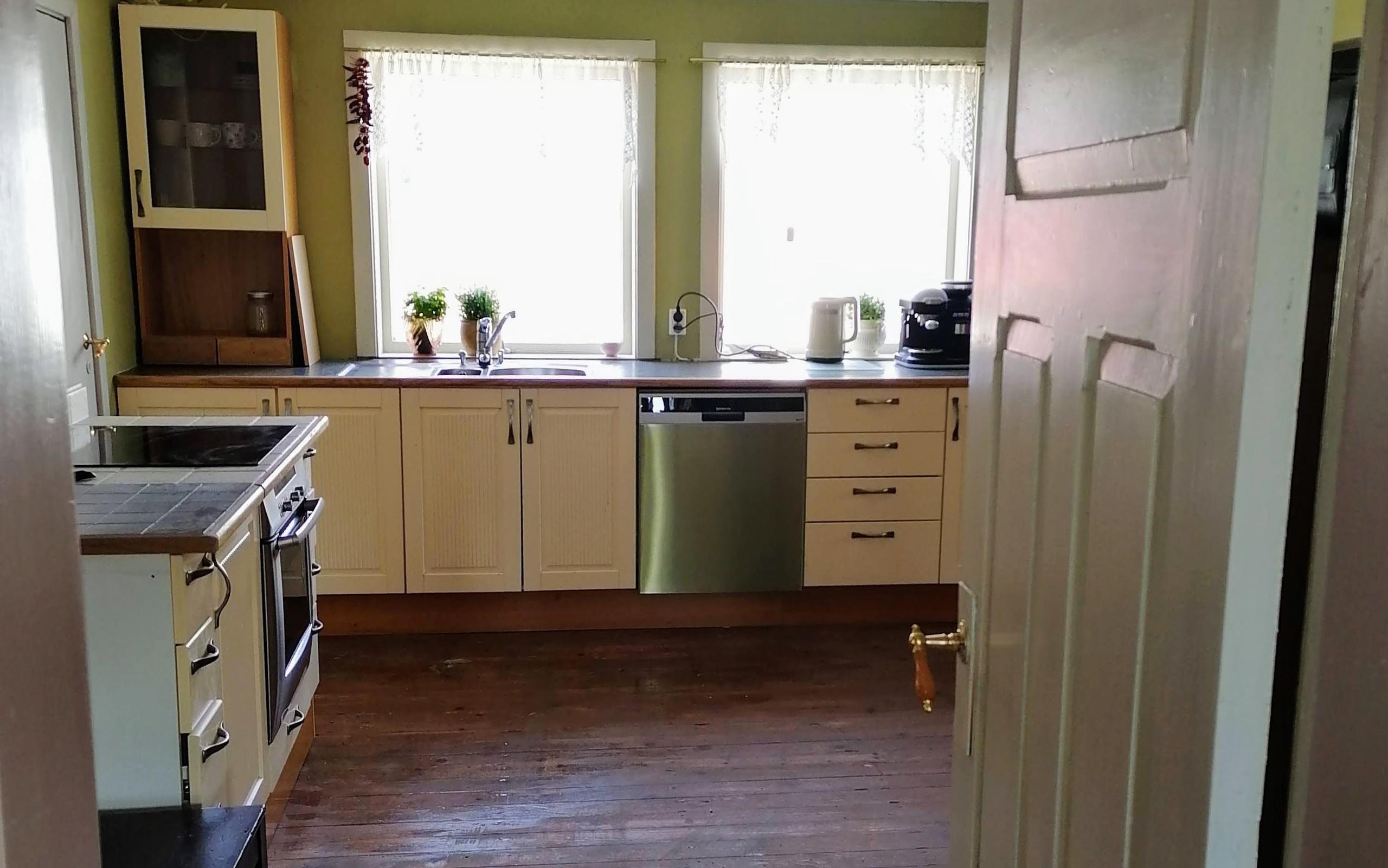 The large country farm kitchen with dishwasher, sink, and wooden floors