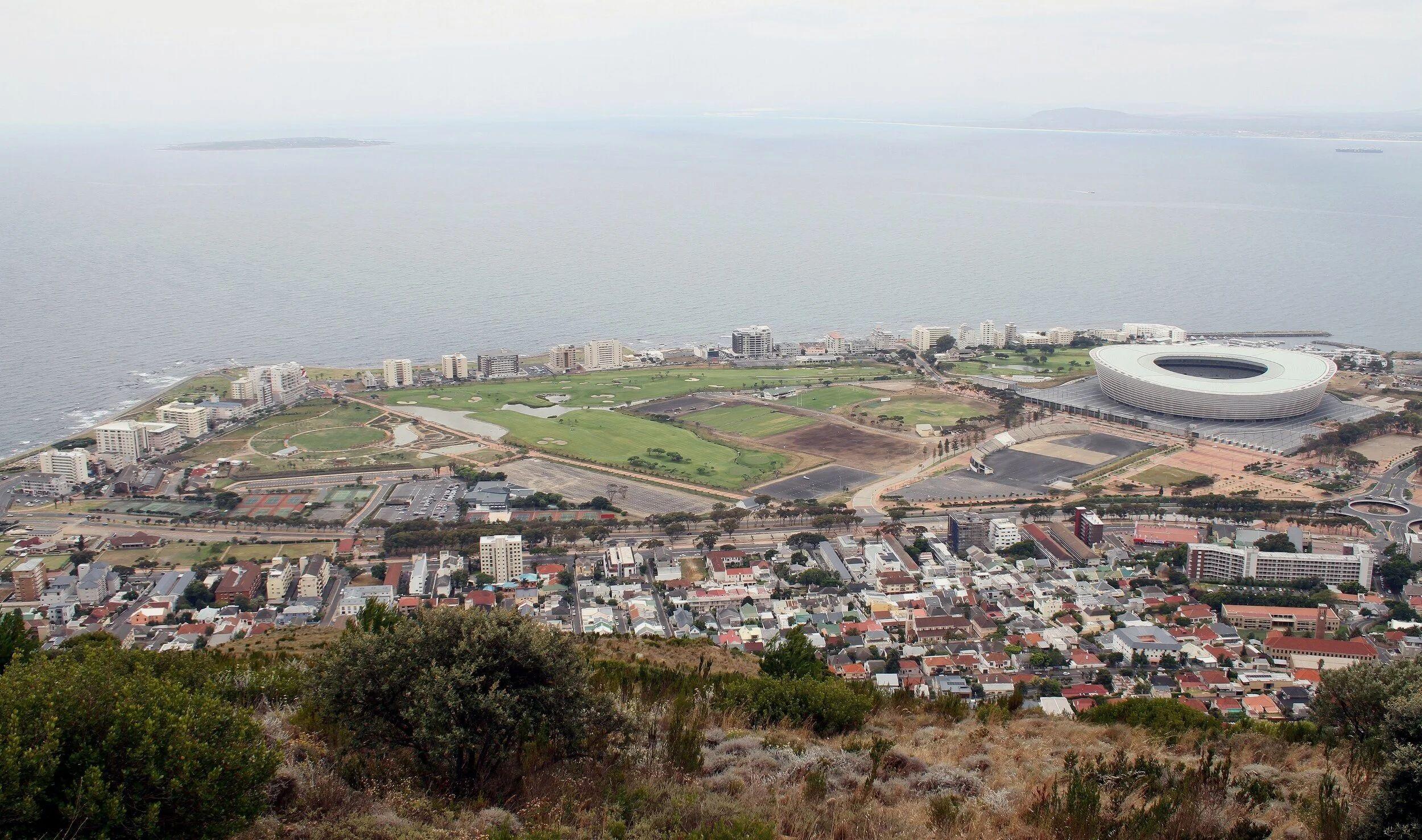 Aerial view of Green Point suburb in Cape Town showing DHL Stadium, Green Point Park, and the Atlantic Ocean