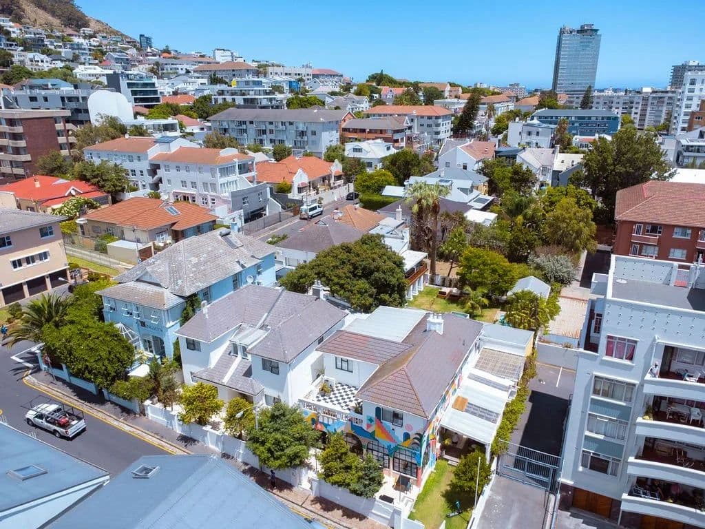 Drone aerial view of Neighbourgood Hill and the surrounding Green Point neighbourhood, with the colourful mural visible on the building roof