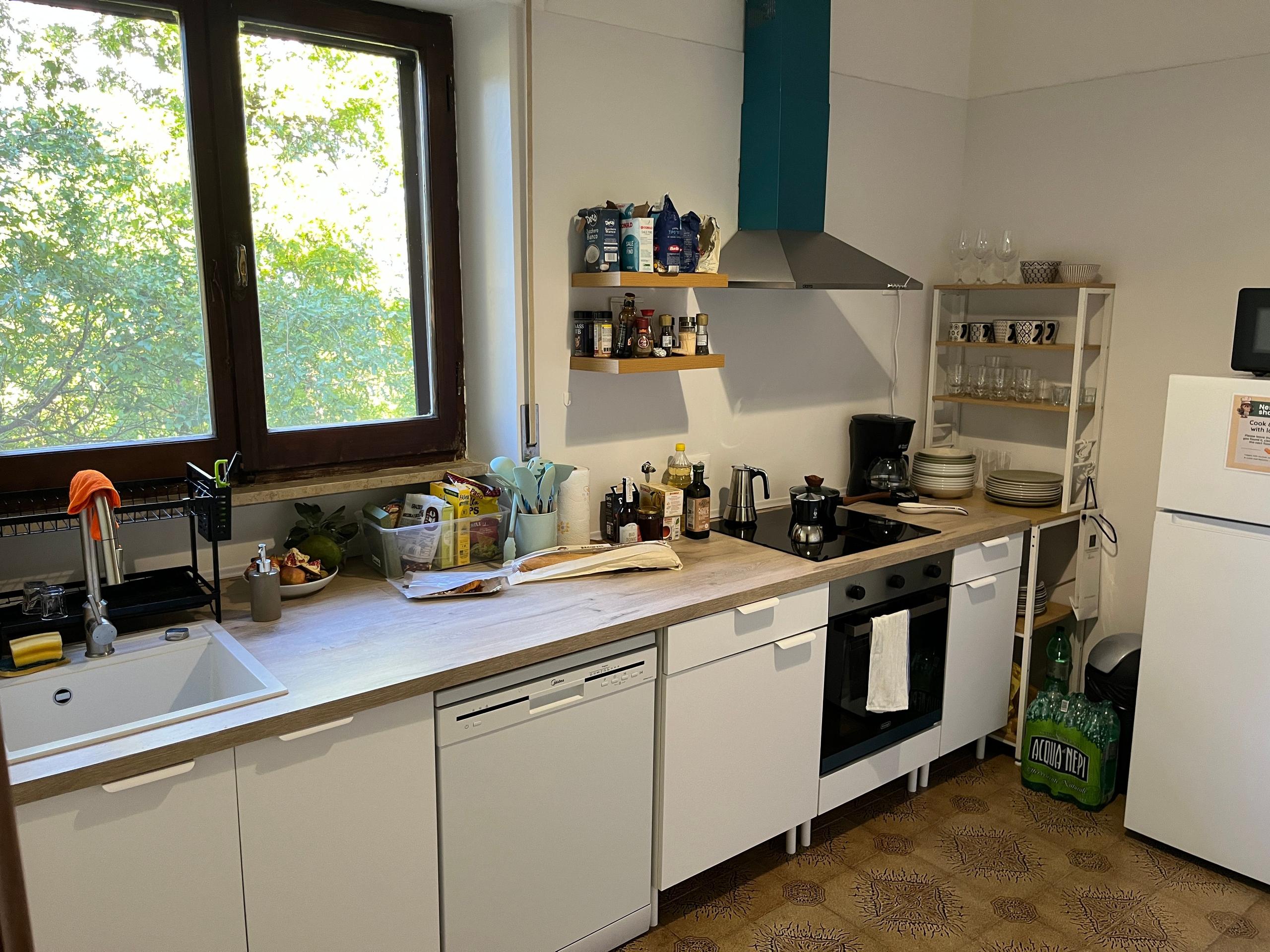 Fully equipped shared kitchen inside a coliving in Italy near Rome