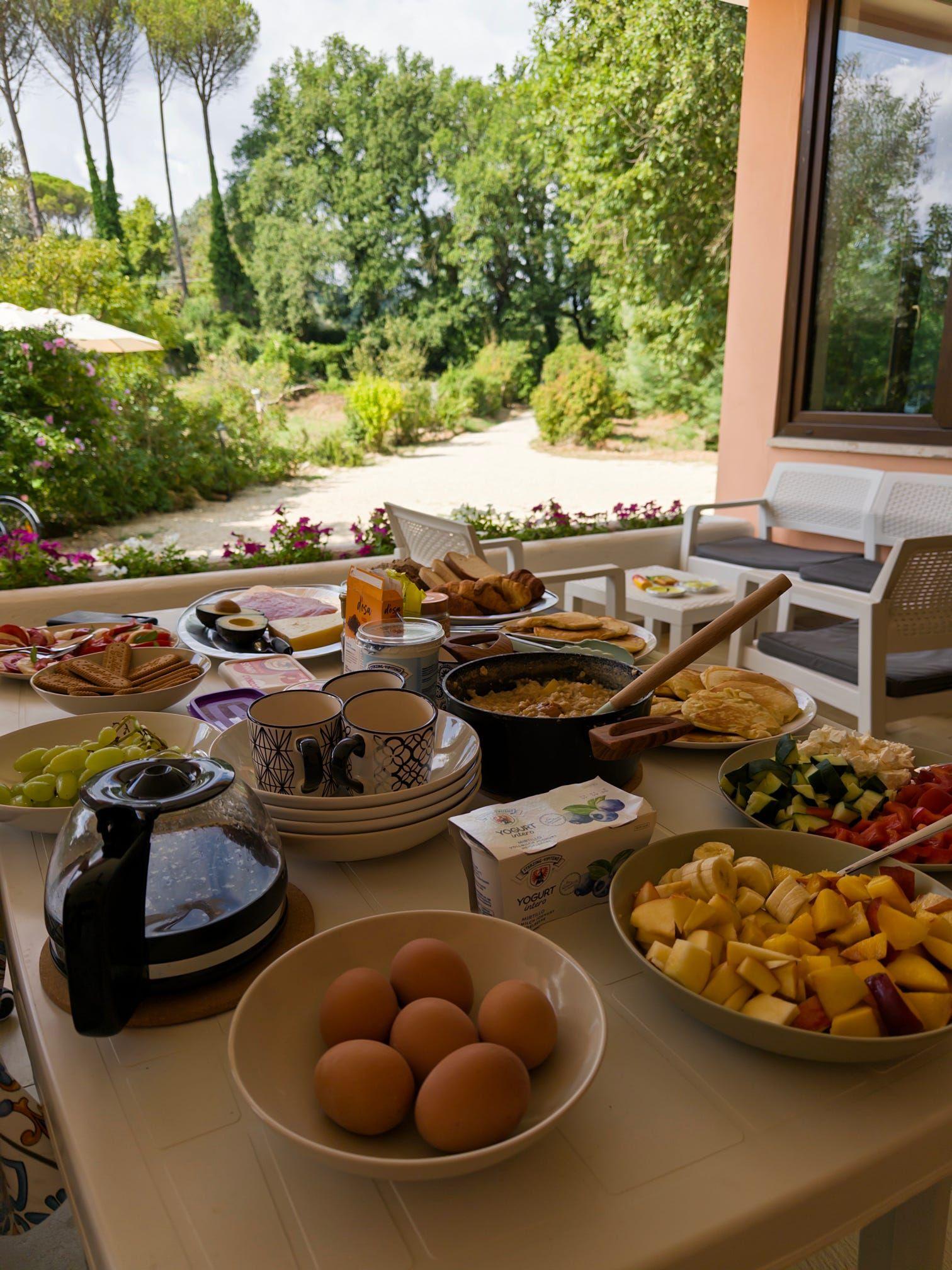 Brunch food displayed on the veranda at a coliving in Italy near Rome