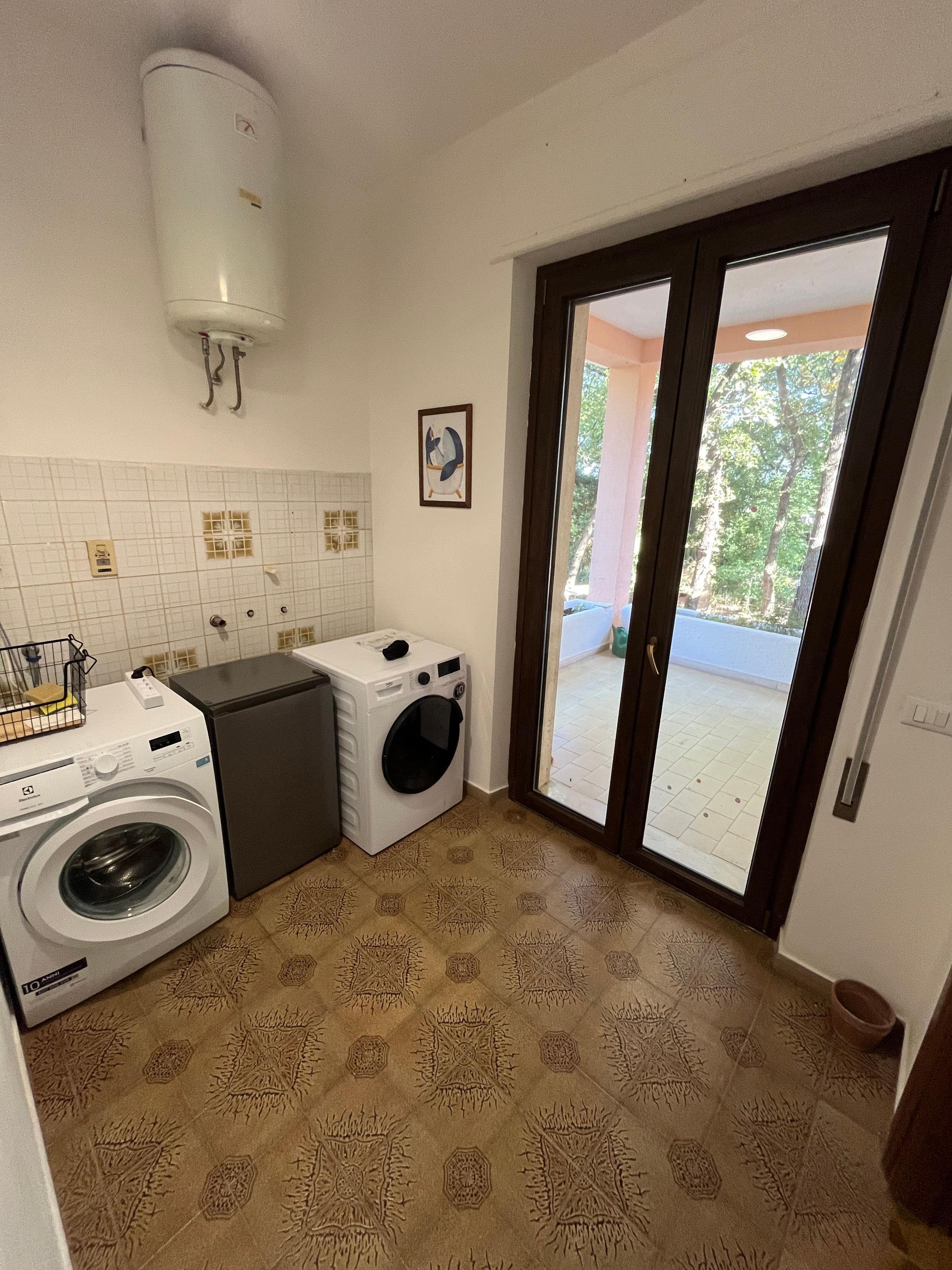 Laundry room with washing machine inside a coliving in Italy near Rome