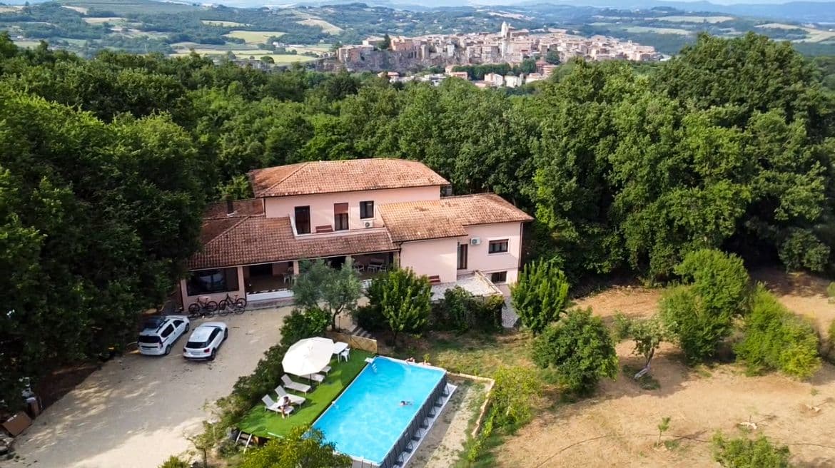 Drone shot of the villa with swimming pool and garden at a coliving in Italy near Rome