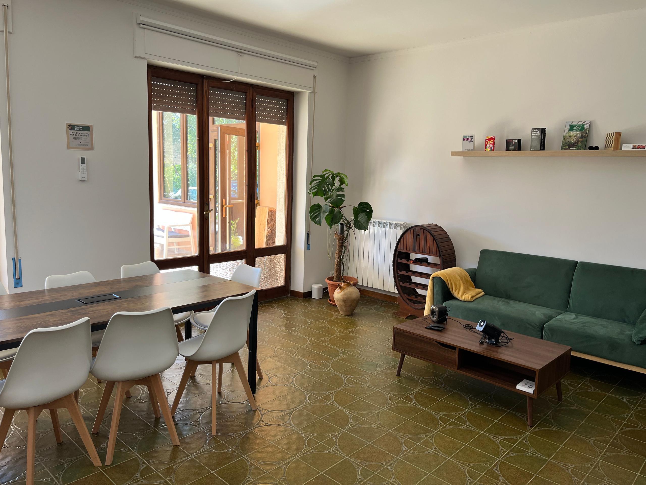 Living room with couches and table inside a coliving in Italy near Rome