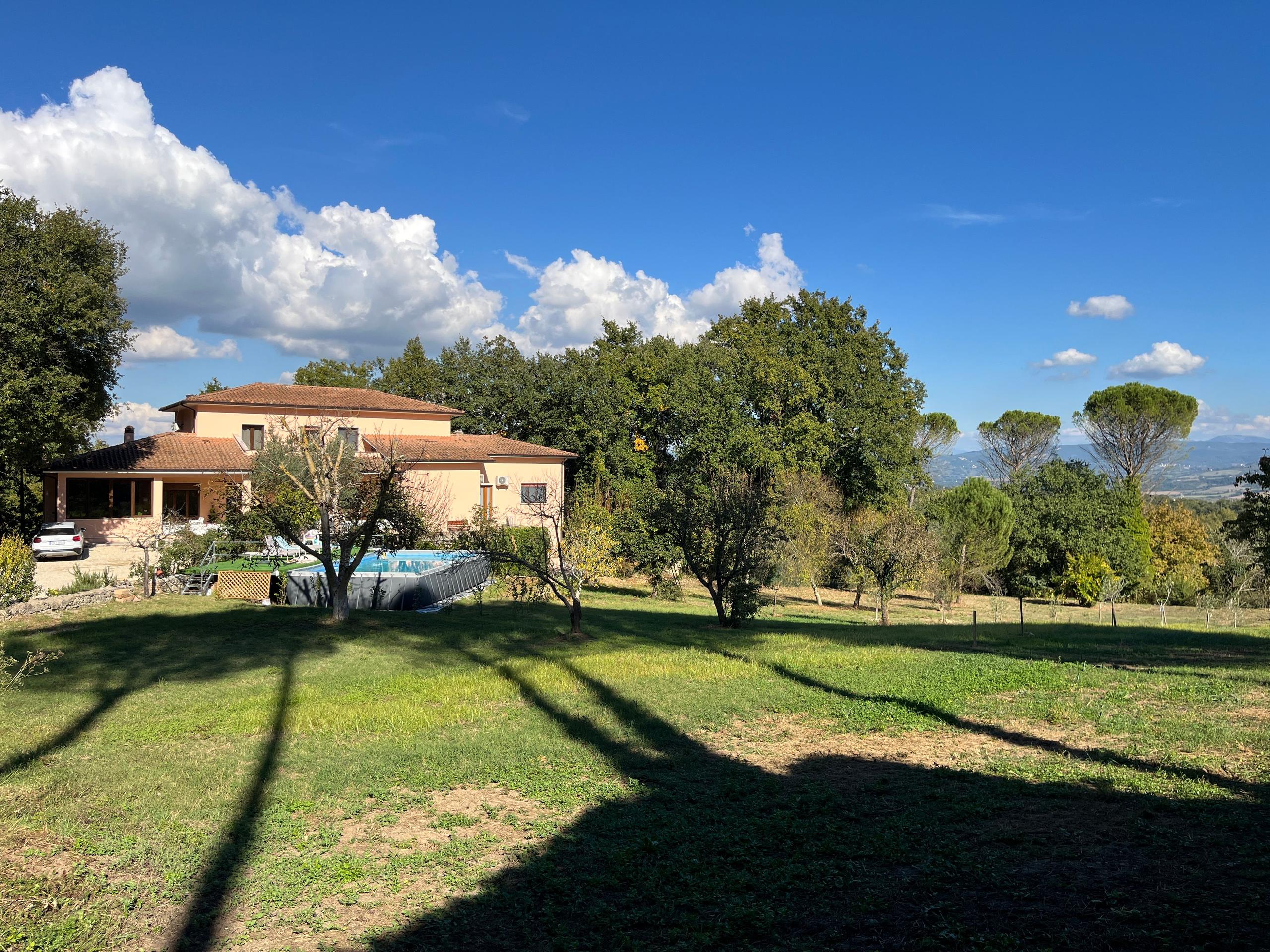 Distant villa view from the garden at a coliving in Italy near Rome