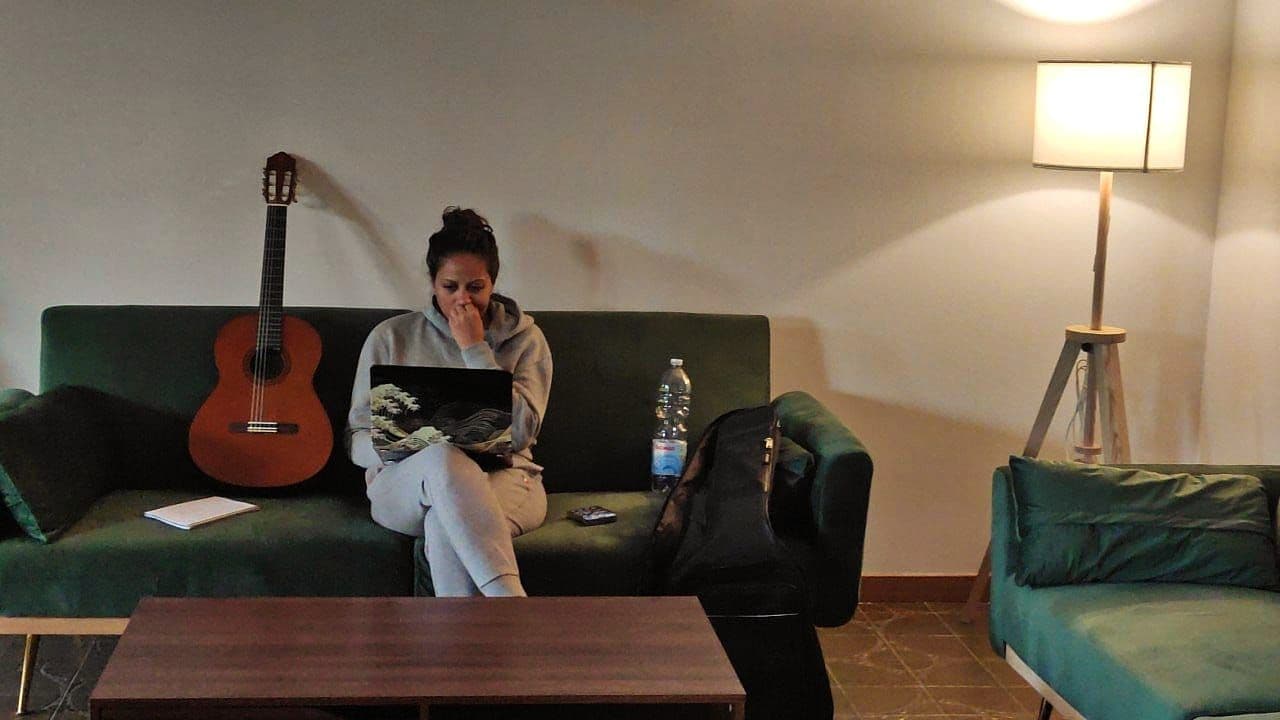 Remote worker working in living room at Nesting Away coliving in Italy