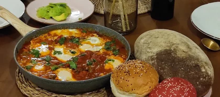 Food delivered from nearby restaurants, arranged on a dining table for guests at NETS Cowork and Colive.