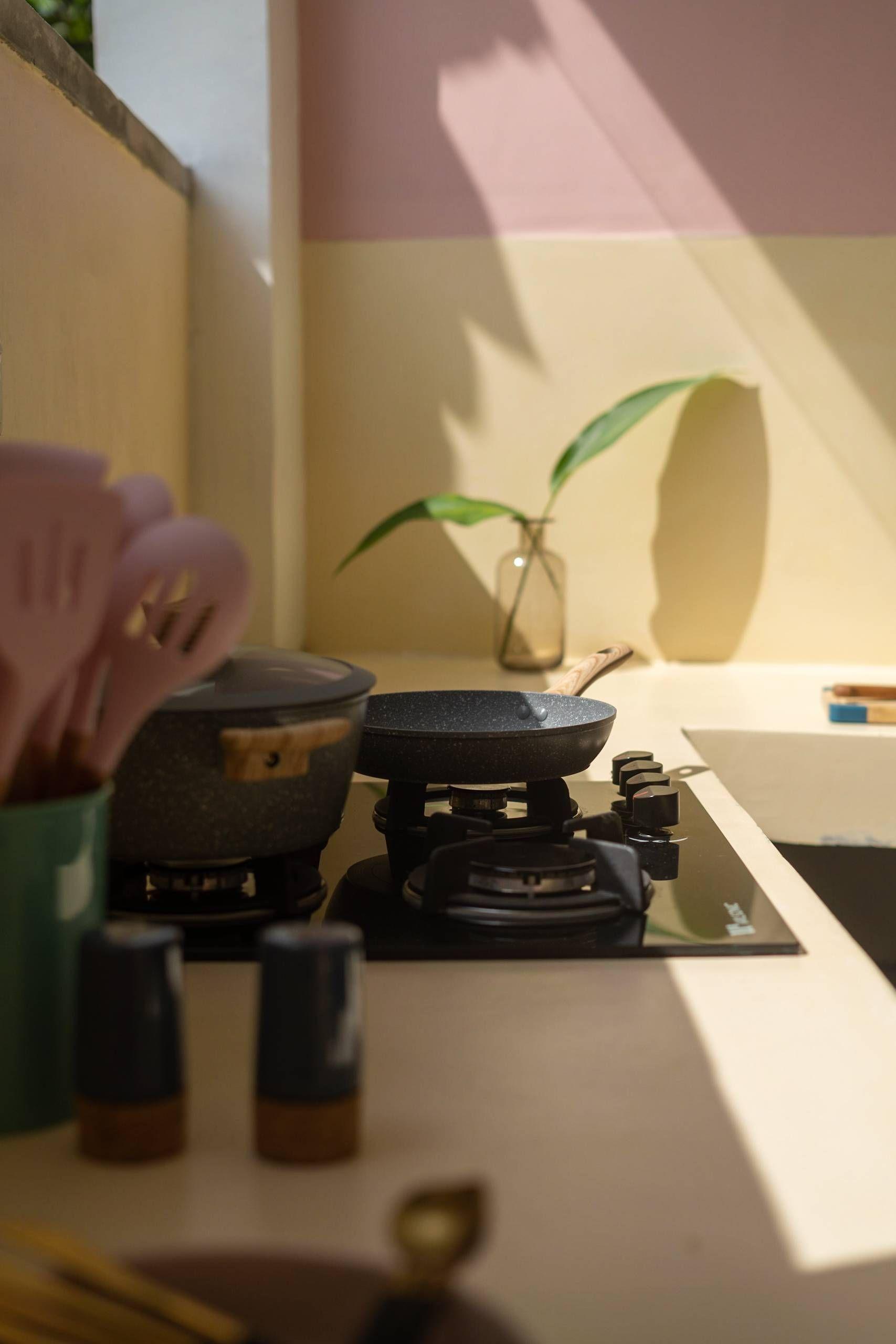 Cooking stove in the co-kitchen area at NETS Cowork and Colive, ready for guests to prepare their meals.