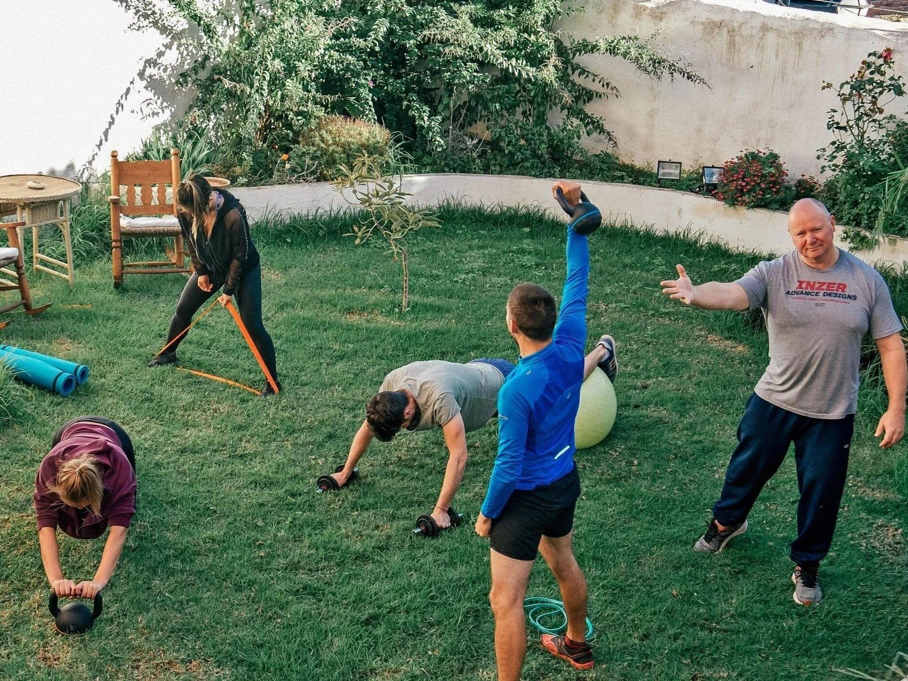 Residents doing a workout session in the garden of Nine Coliving.
