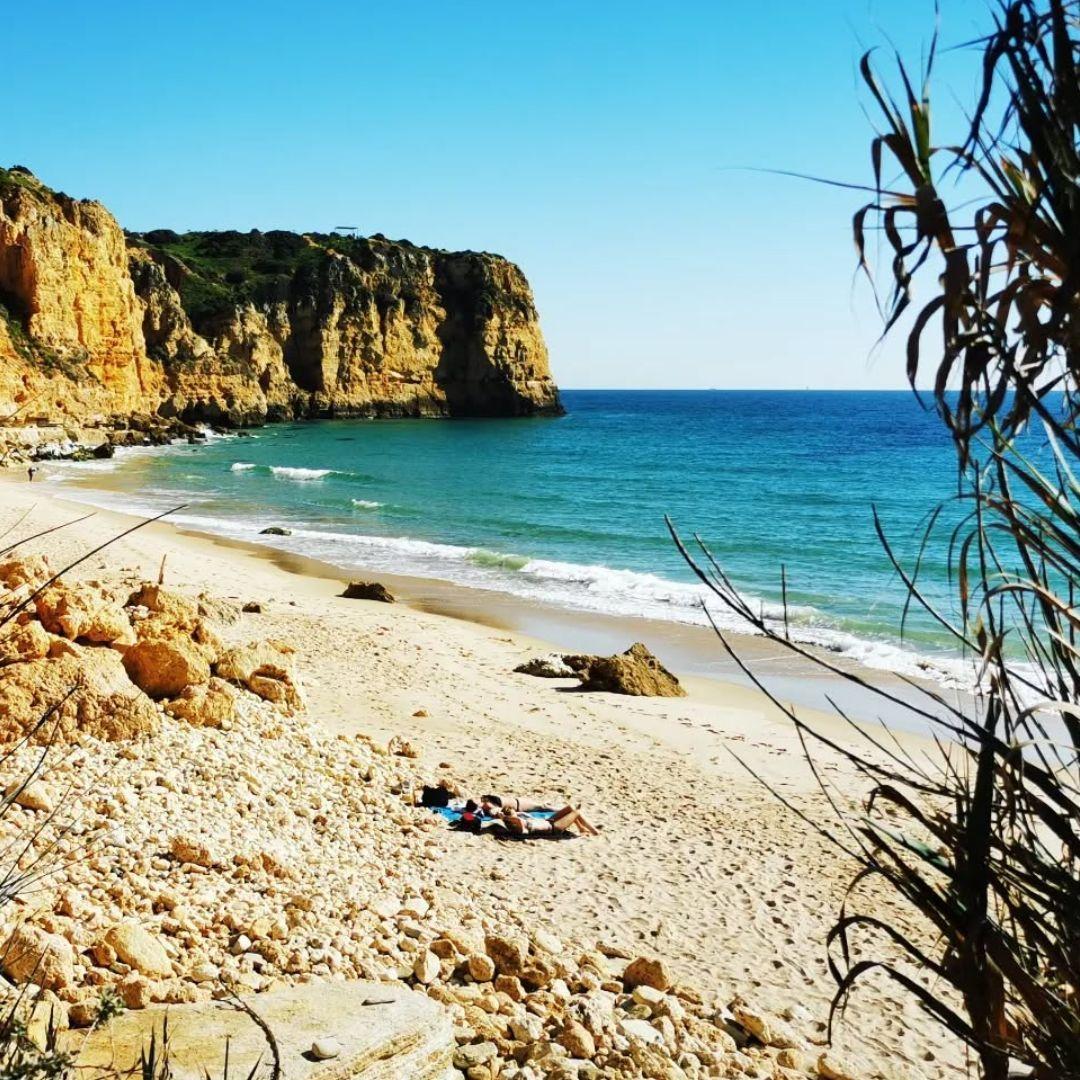 Beaches next door — golden sandy beach with turquoise water and dramatic cliffs near Lagos