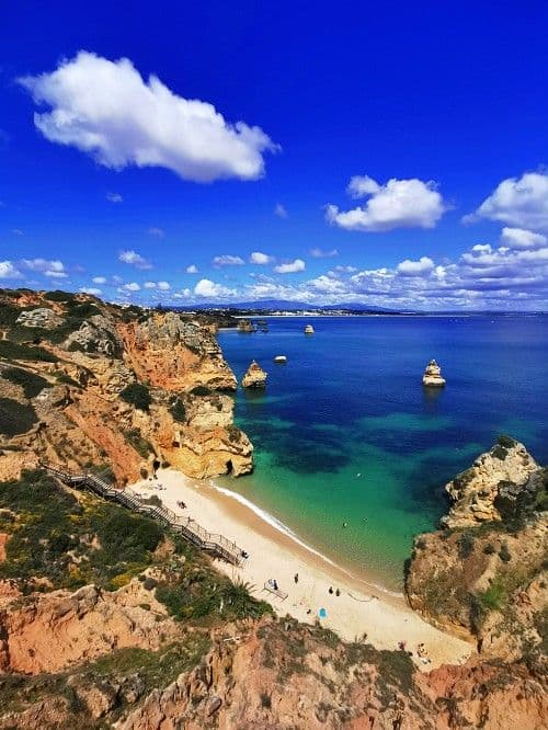 Golden cliff beaches near Noma Village coliving Lagos Algarve Portugal surf spots — aerial view of Praia Dona Ana
