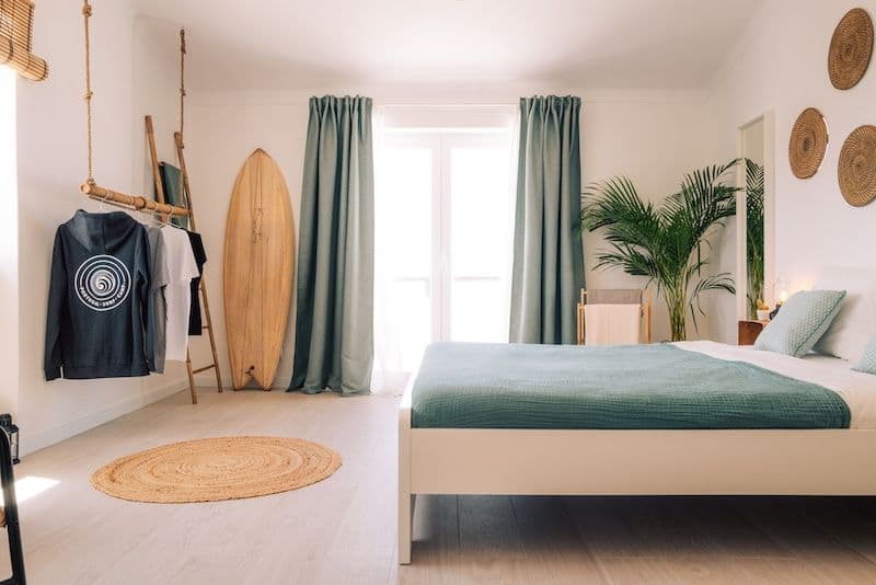 Bright private bedroom with surfboard decor and sea view at the Sea View Hub