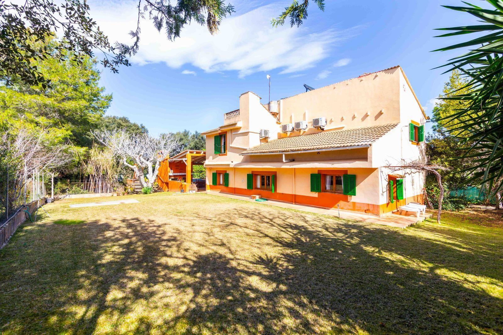 Exterior view of the coliving home with the large garden in the foreground