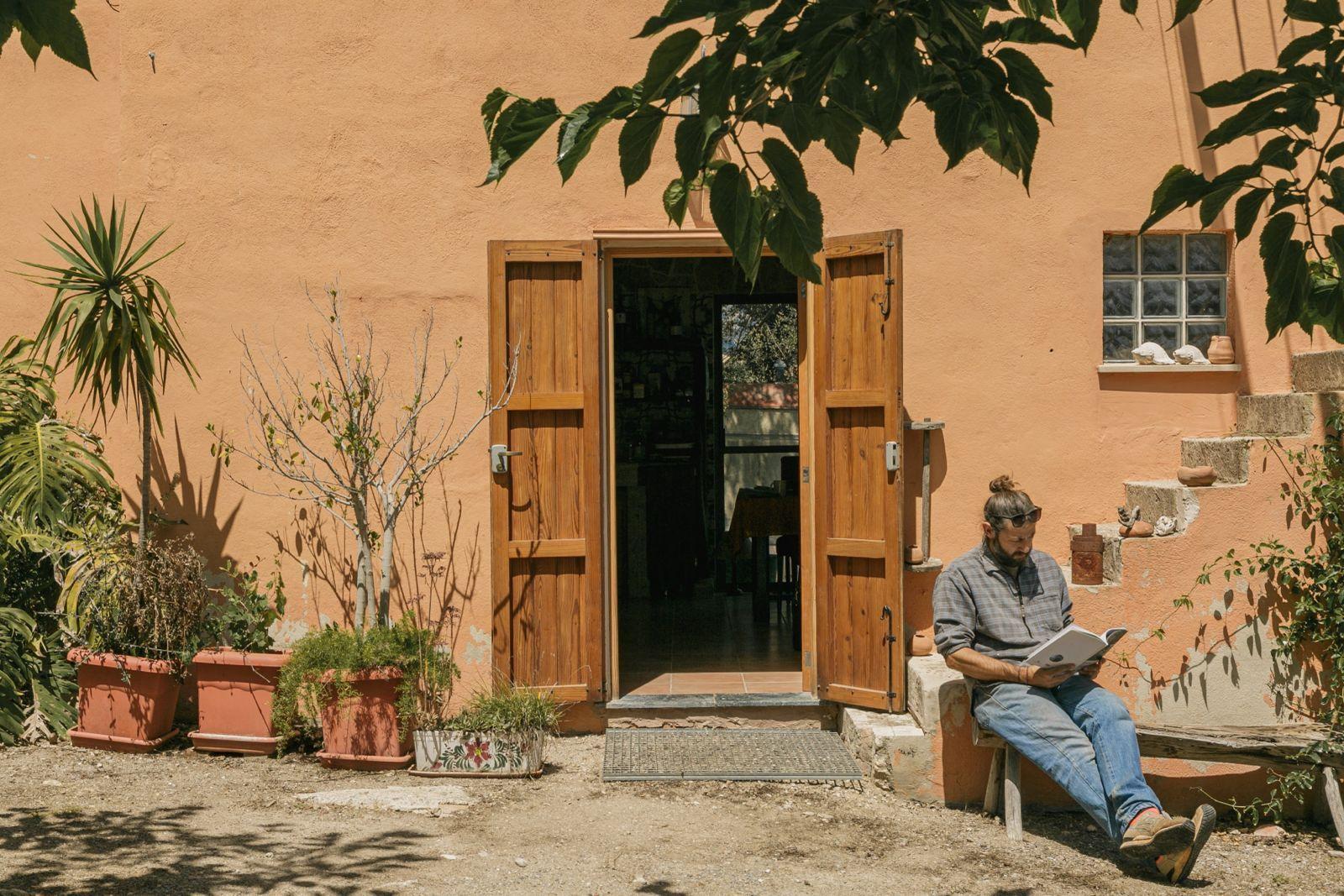 Guest reading outside the entrance of the coworking house
