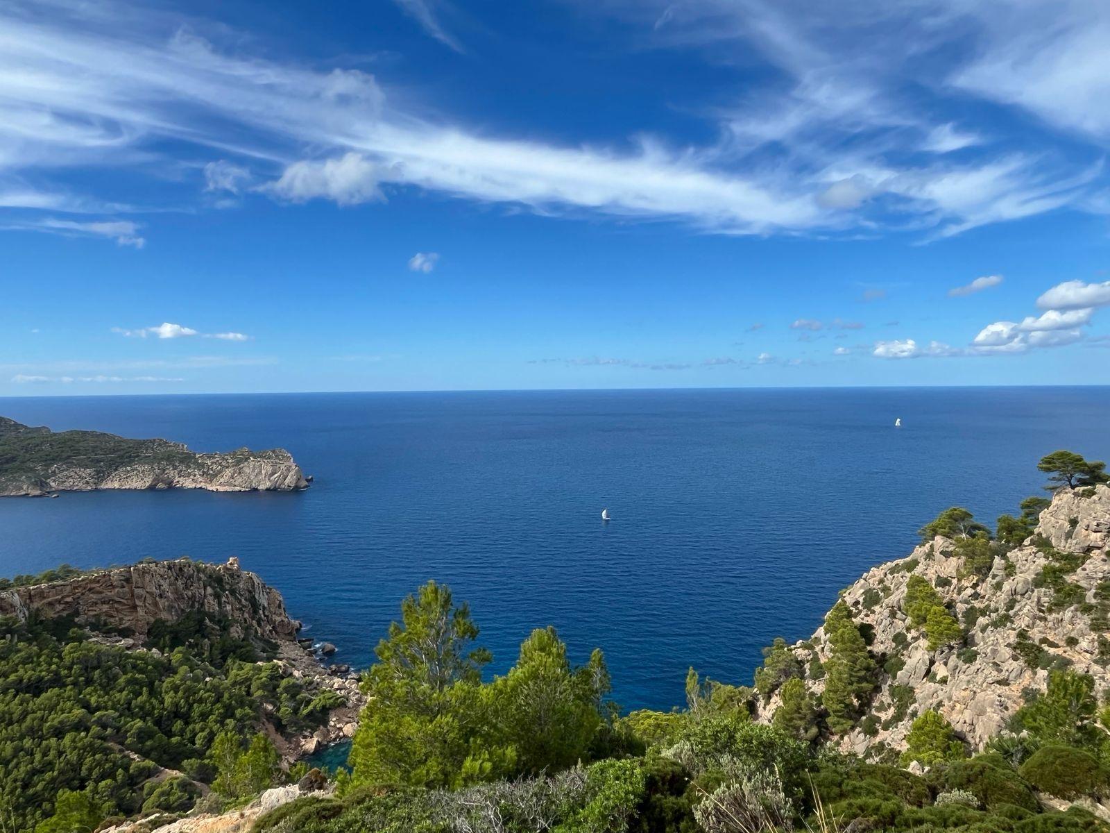 Panoramic view of the Mallorcan coastline with rocky cliffs and blue sea