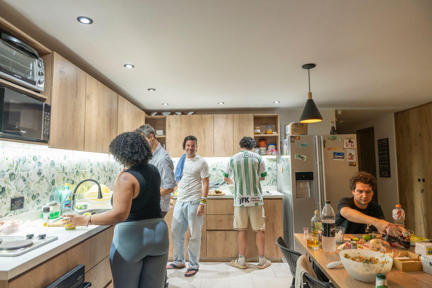 Residents gathered in the shared kitchen cooking and socializing together