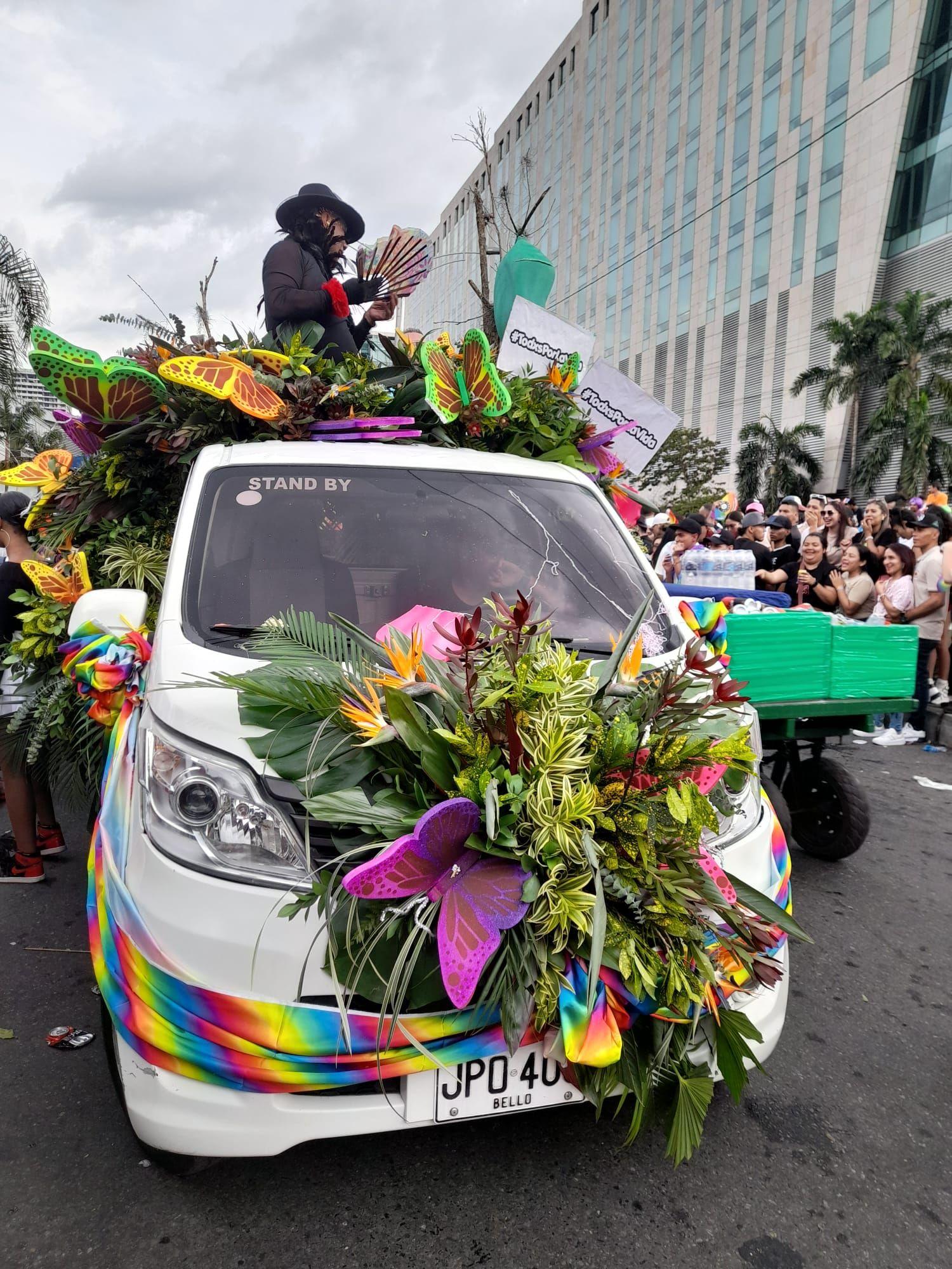Colorful flower-decorated vehicle in a Medellin street parade or festival