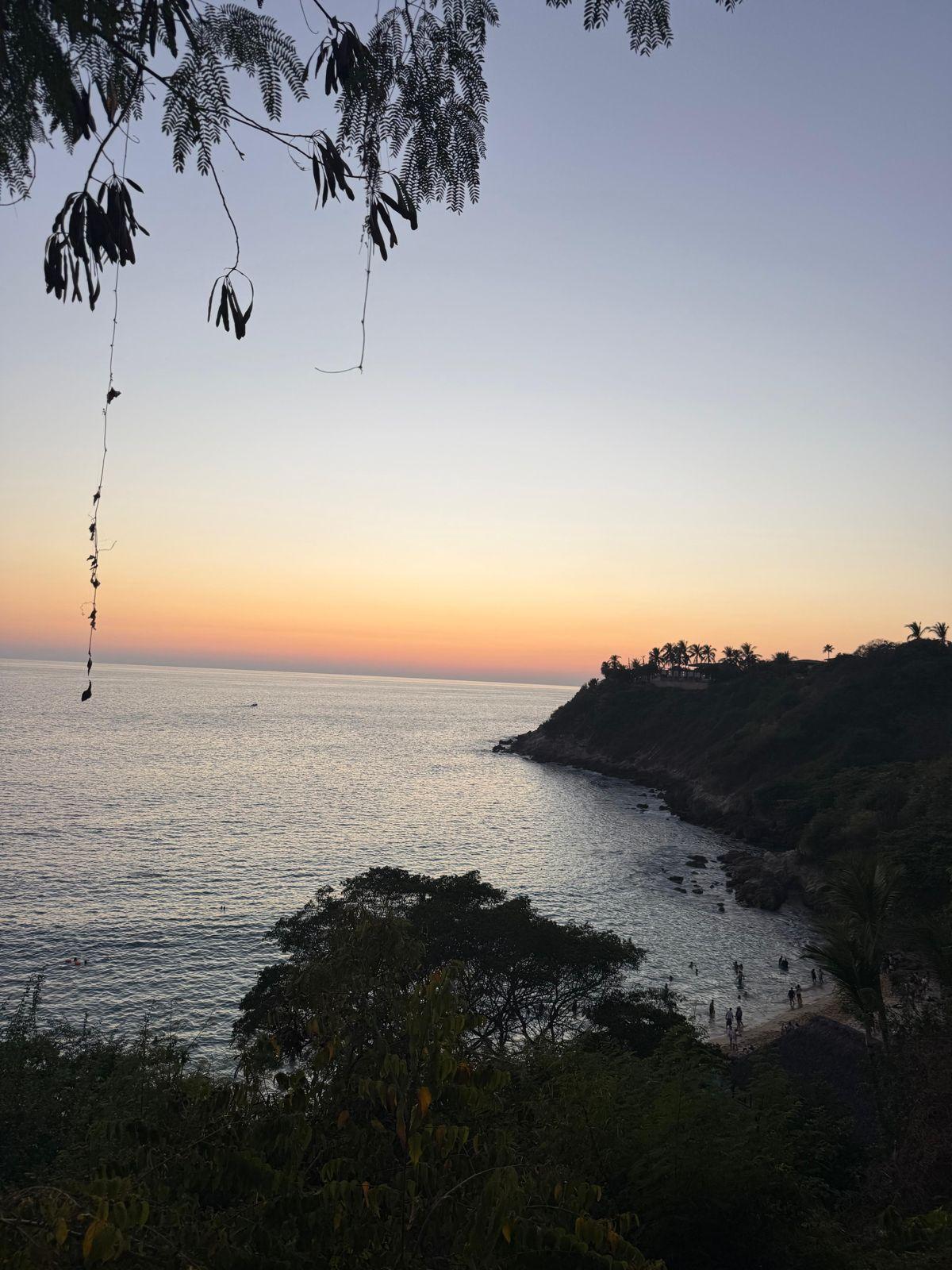 Beautiful sunset over the ocean and cliffs at Puerto Escondido