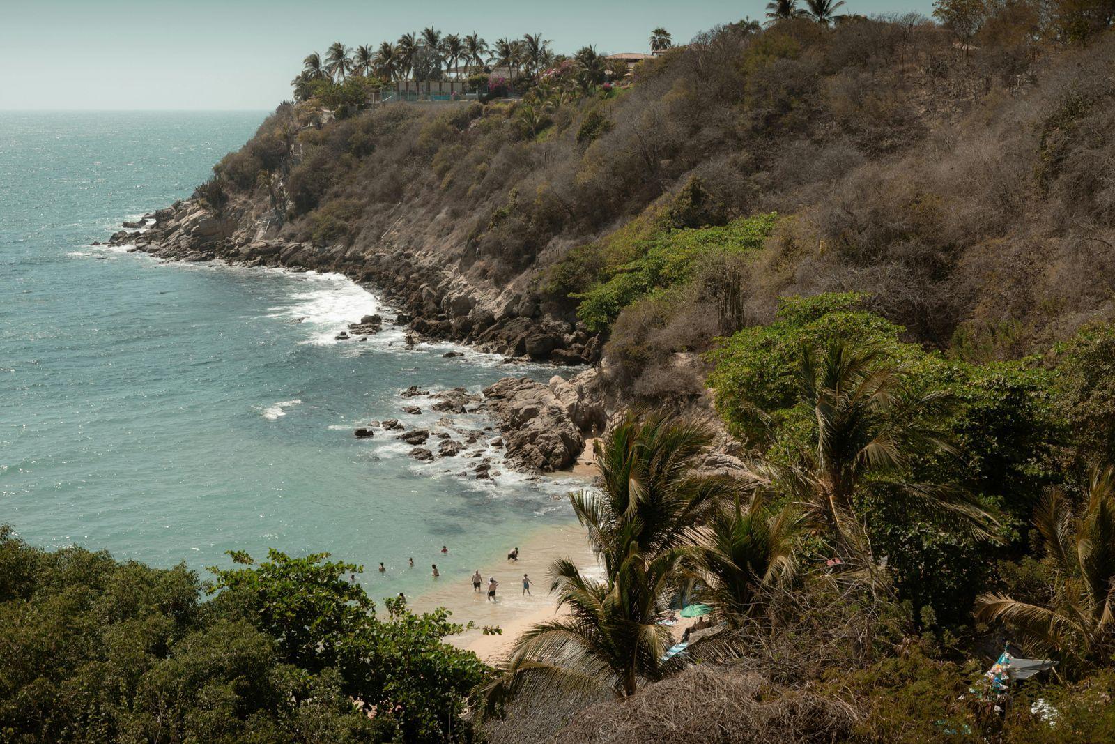 Scenic coastal cliffs and hidden beach near Puerto Escondido