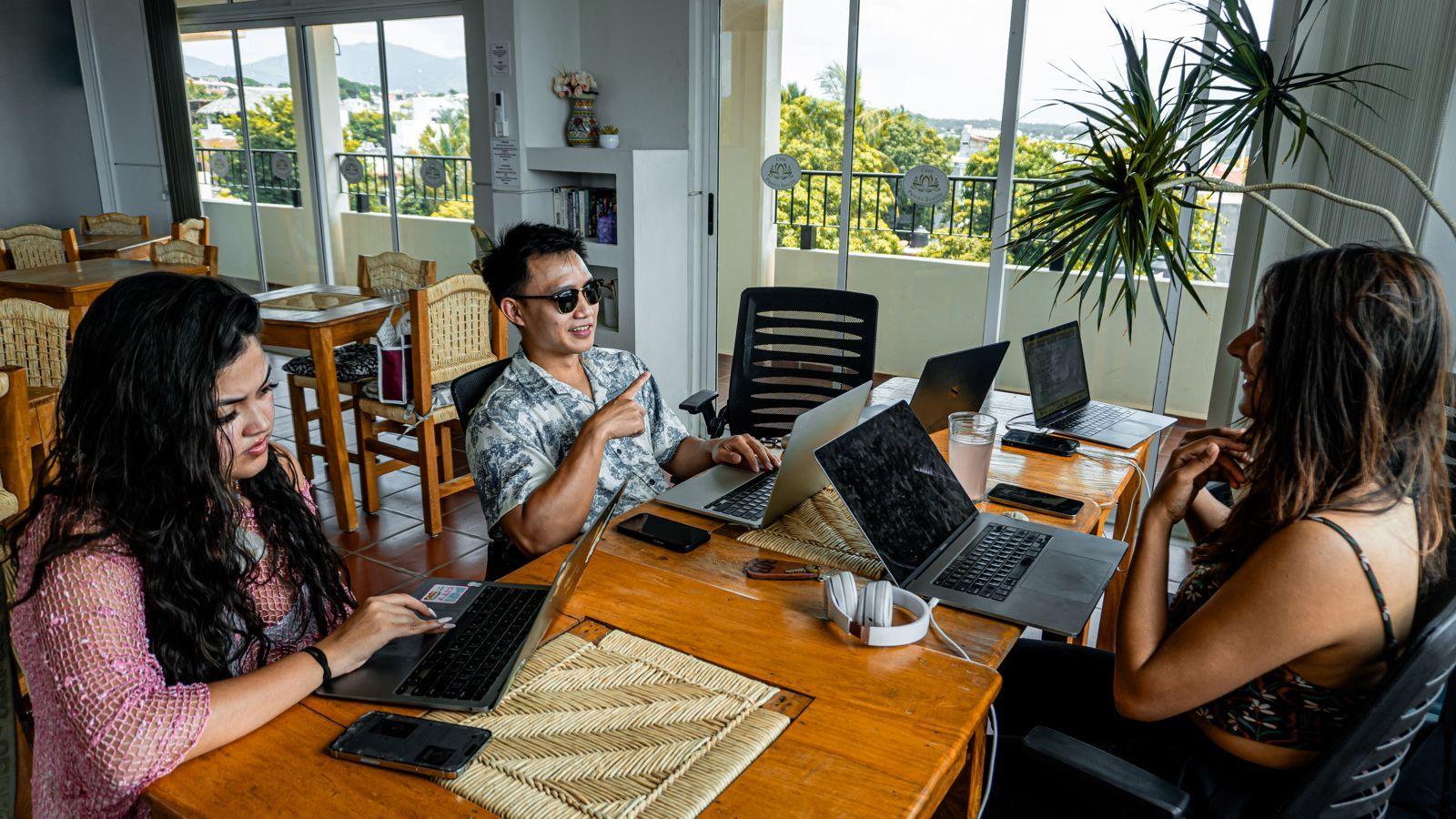 Crew with a view - people working on laptops in the coworking space with ocean views