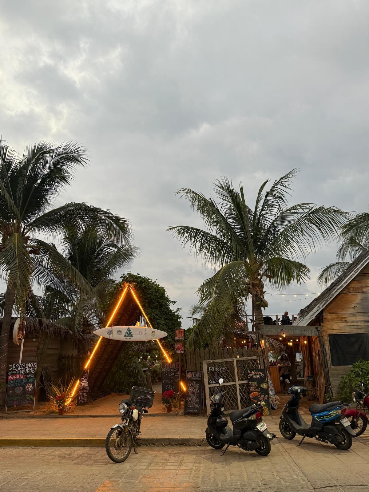 Restaurant in Puerto Escondido at night with string lights and bougainvillea