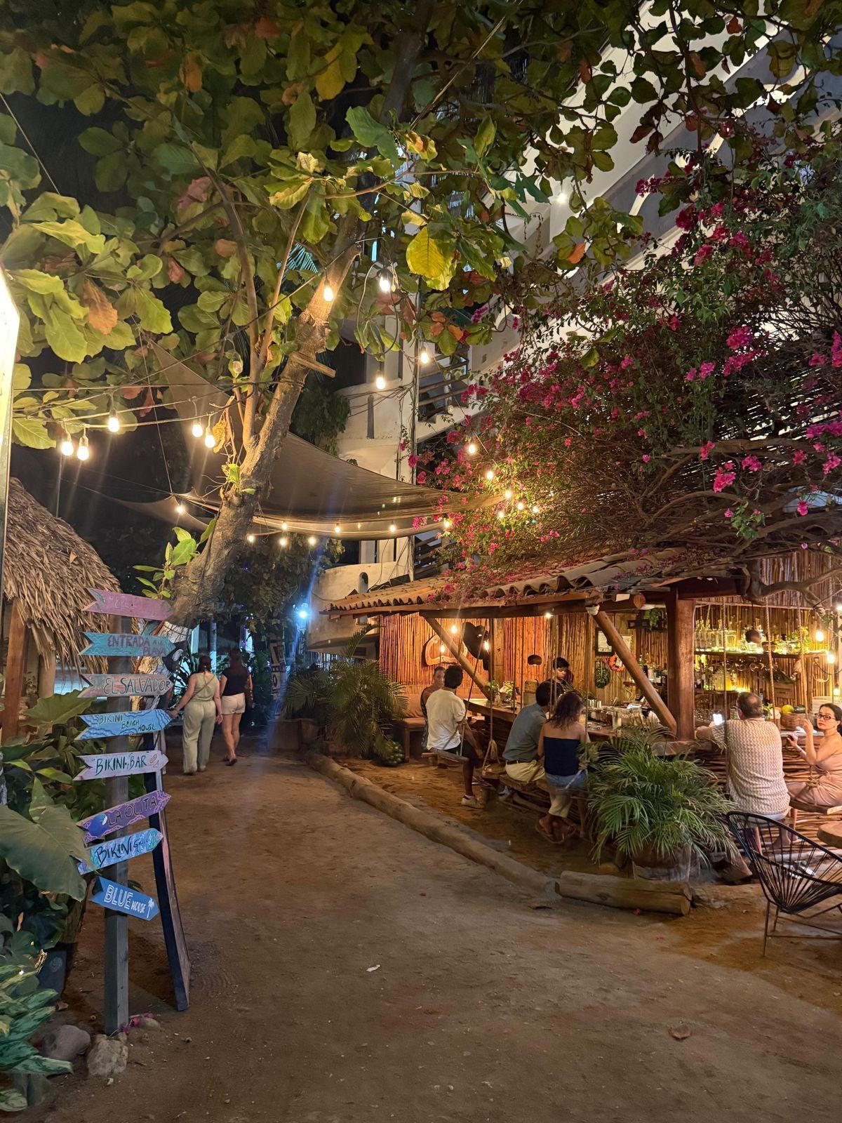 La Punta restaurant and bar area at night with string lights and palm trees