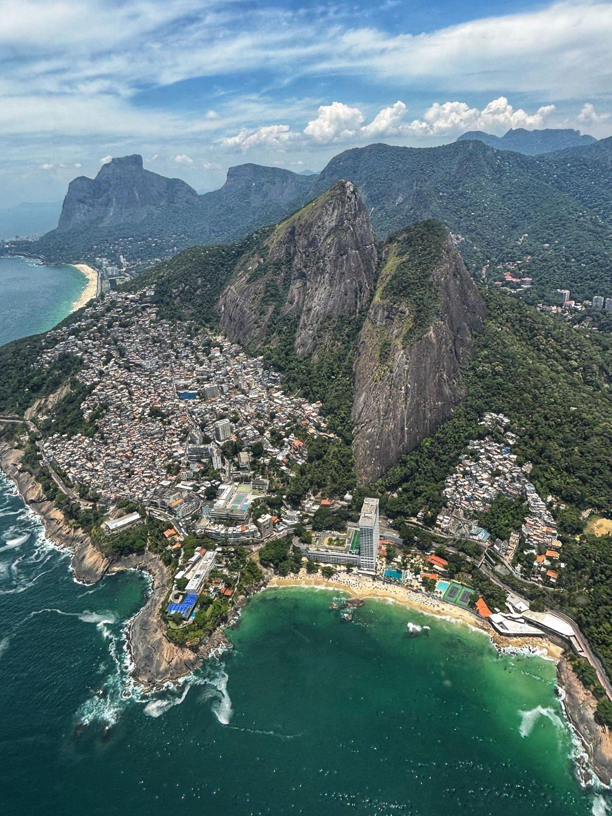 Aerial view of Rio de Janeiro's coastline showing Vidigal favela, Morro Dois Irmãos, and São Conrado beach