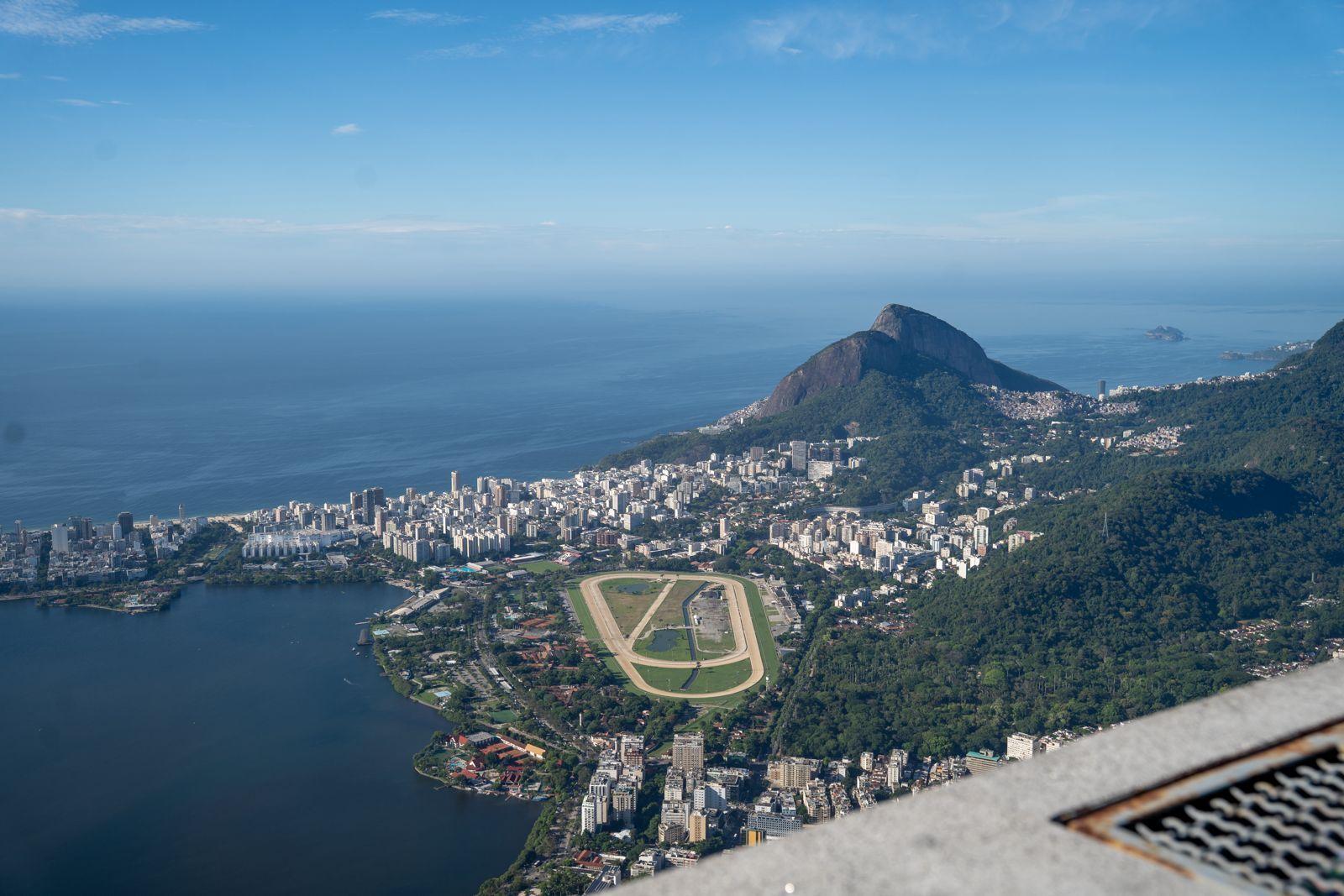 Aerial view of Rio de Janeiro showing the Jockey Club racetrack, Rodrigo de Freitas lagoon, and mountains in the background