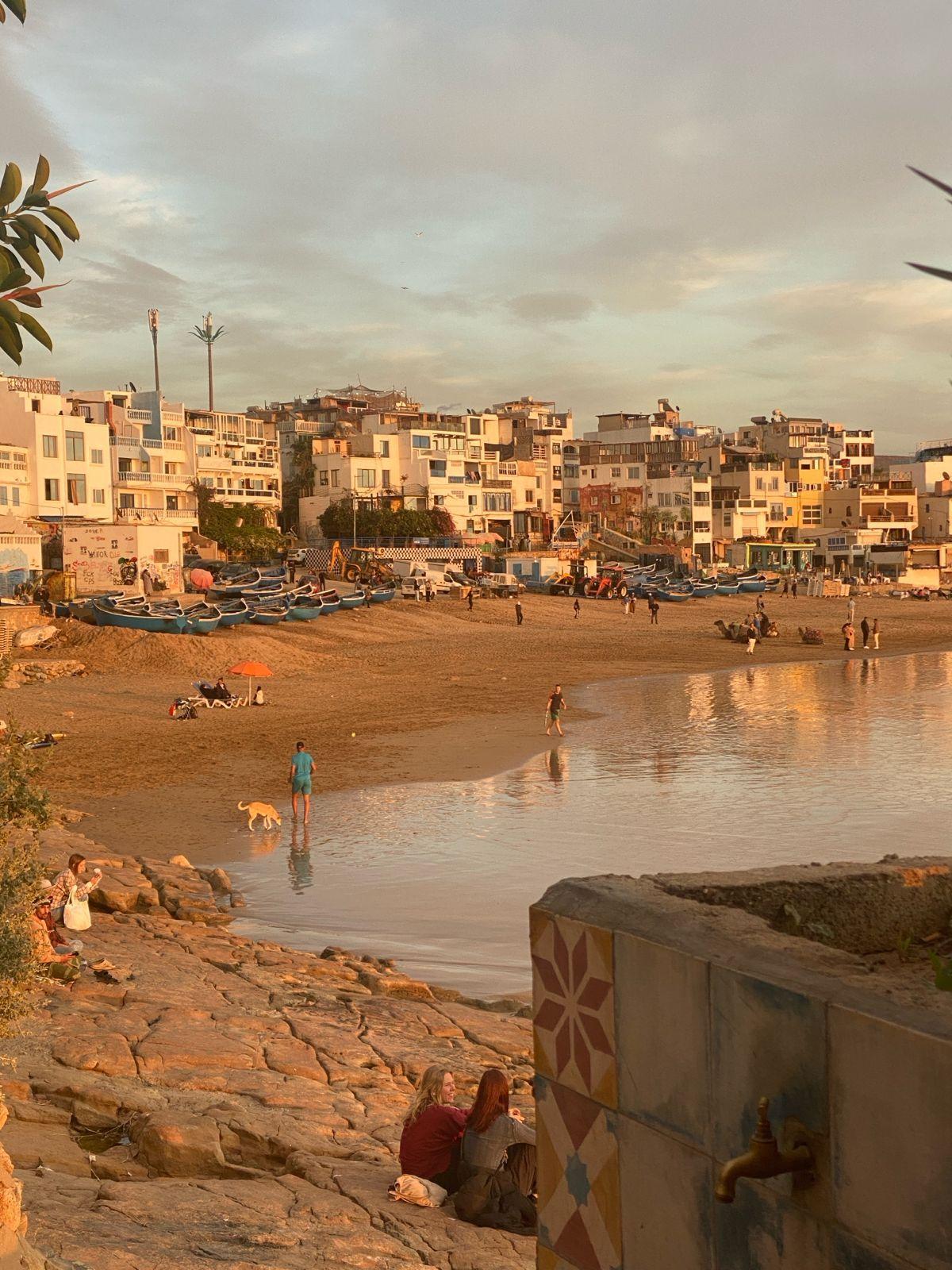 Panoramic view of Tamraght village at sunset with warm orange sky
