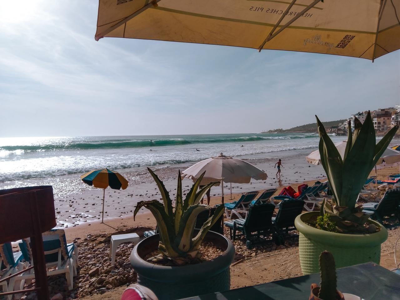 View of the beach and ocean from a café terrace in Taghazout Bay