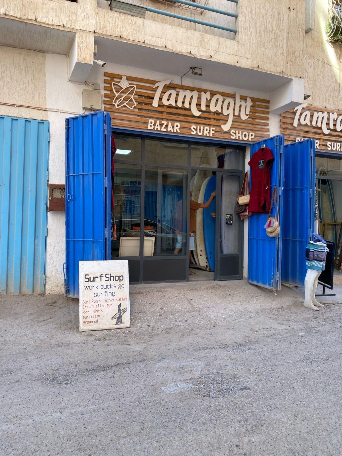 Exterior of Tamraght Bazar Surf Shop with surfboards and gear on display