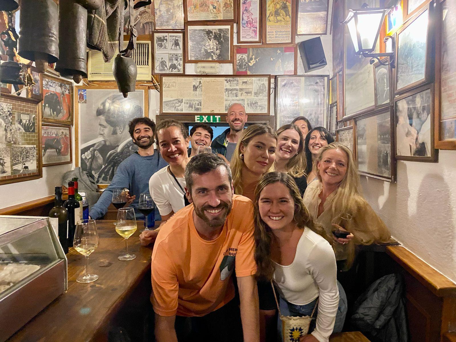 Community members enjoying a group dinner at a local tapas bar in Tarifa