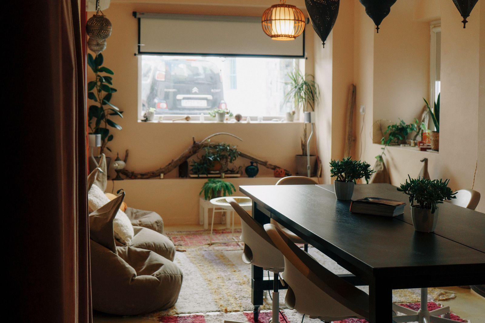 Coworking space at Tarifa Casa with a large table, chairs, bean bag seating, and Moroccan-style pendant lights
