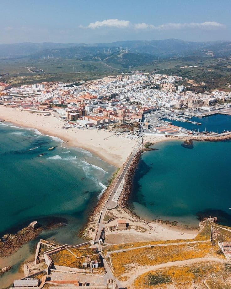 Aerial drone view of Tarifa town showing the beach, harbor, and surrounding landscape