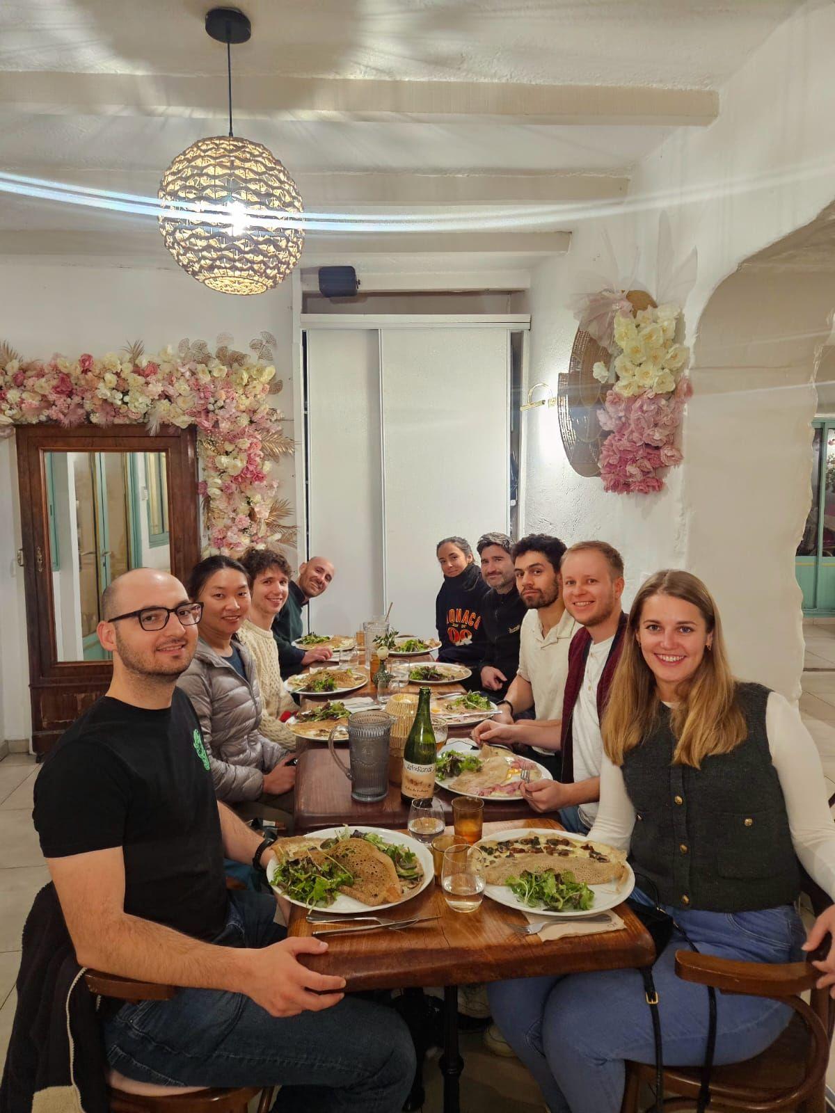 Group of NomadUnion coliving residents sharing a dinner at a restaurant