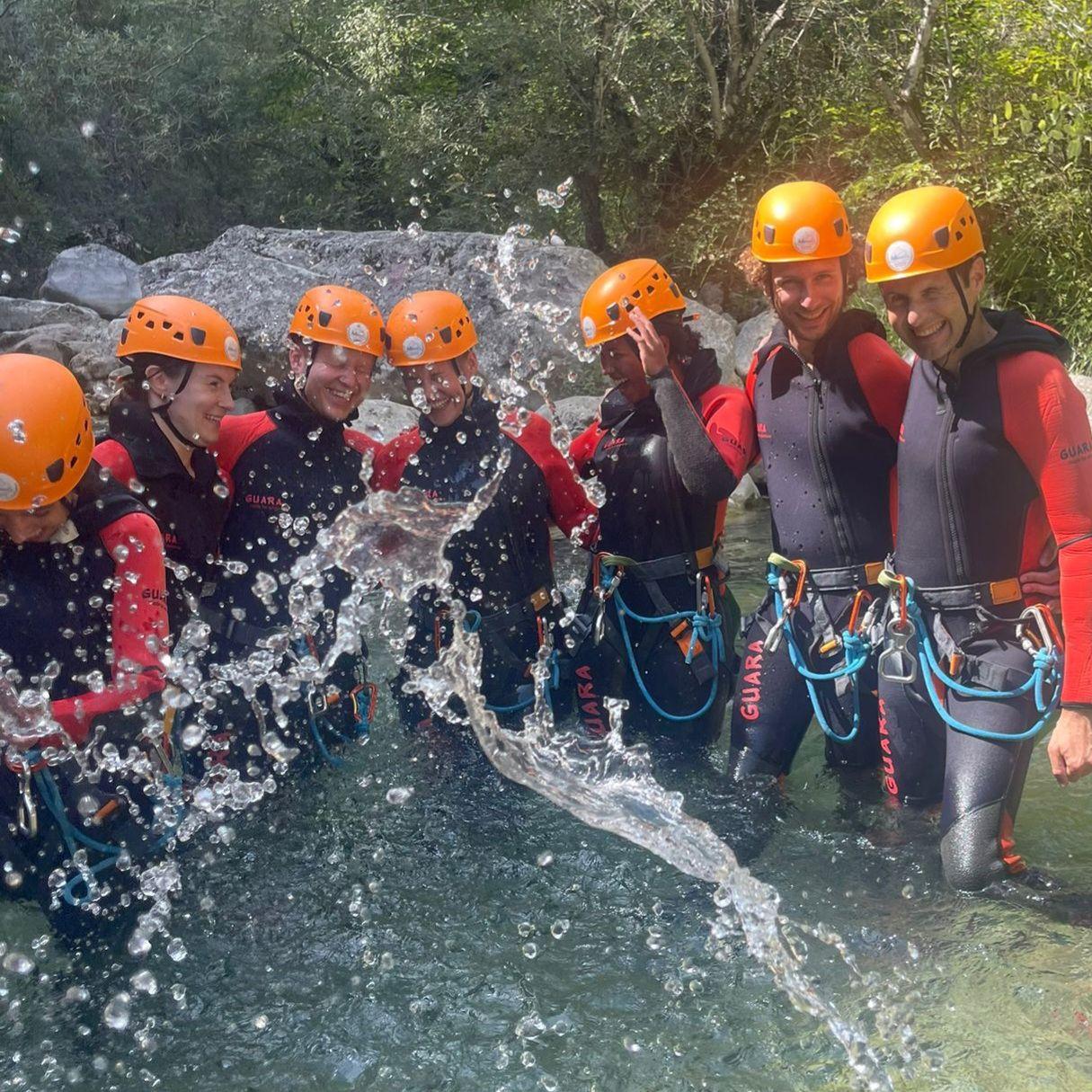 Group of coliving residents on a canyoning excursion in a mountain river