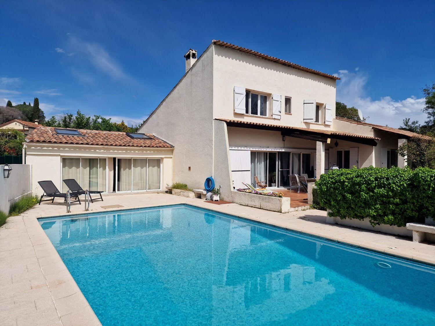 Exterior view of the BIOTiful Villa with the large swimming pool in the foreground and the villa building behind it