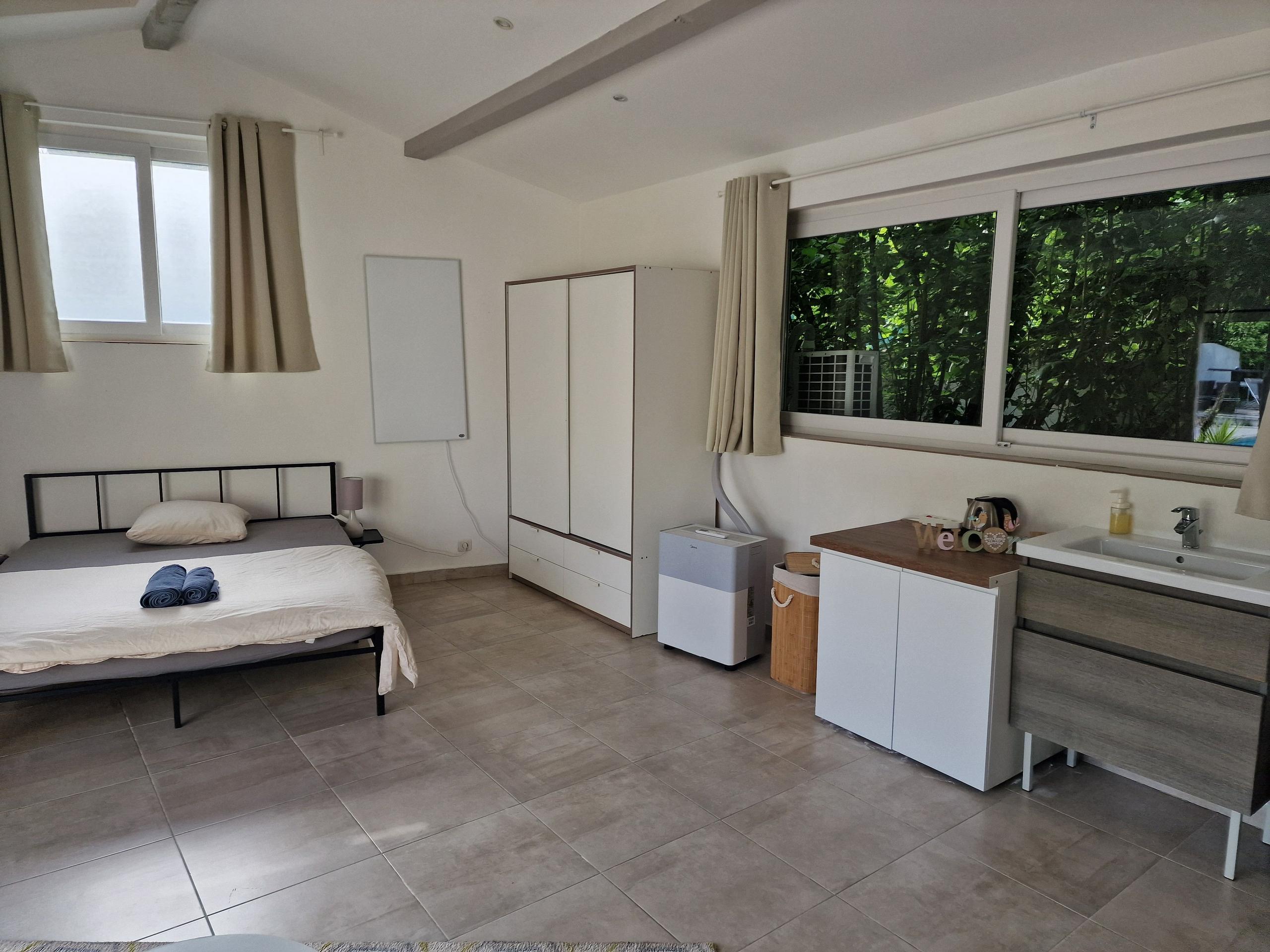 Room Monaco showing the kitchenette area with wardrobe and private sink