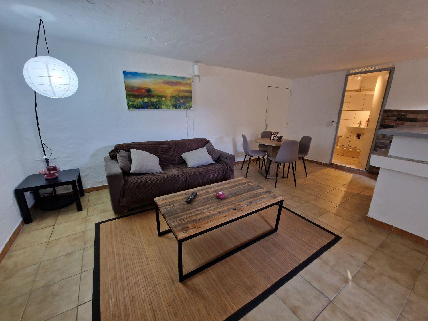 Marseille shared flat living room with sofa, coffee table, and dining area visible